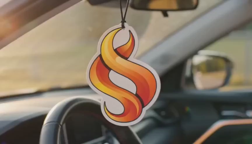 Various custom air fresheners being shown in a car